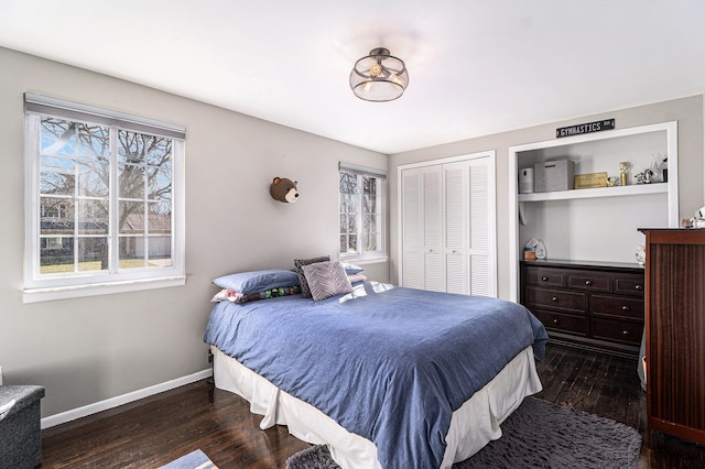 bedroom featuring baseboards, multiple windows, and wood finished floors