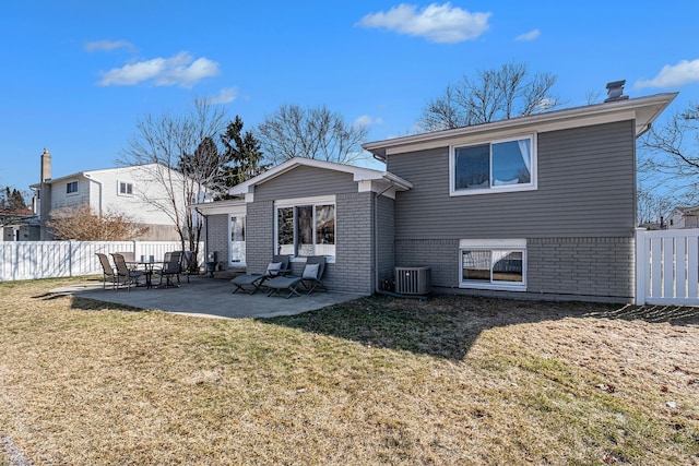 rear view of property featuring a patio area, central AC unit, a lawn, and fence