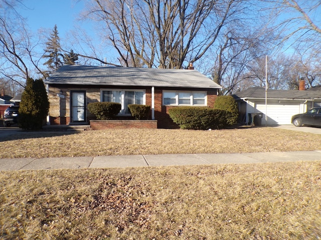 view of front of house featuring a garage, brick siding, and an outdoor structure