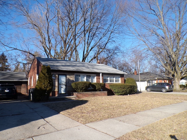 view of front facade featuring a garage, brick siding, and driveway