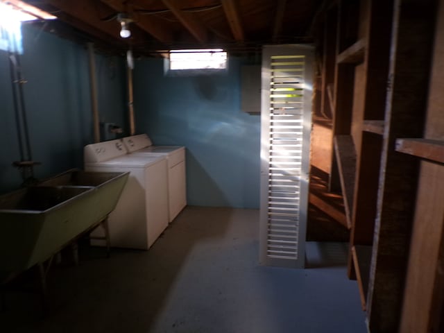 basement featuring independent washer and dryer and a sink