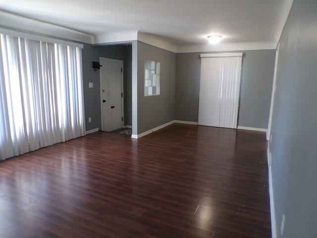 interior space featuring baseboards and wood finished floors