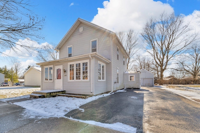 view of front of home featuring a garage and an outdoor structure