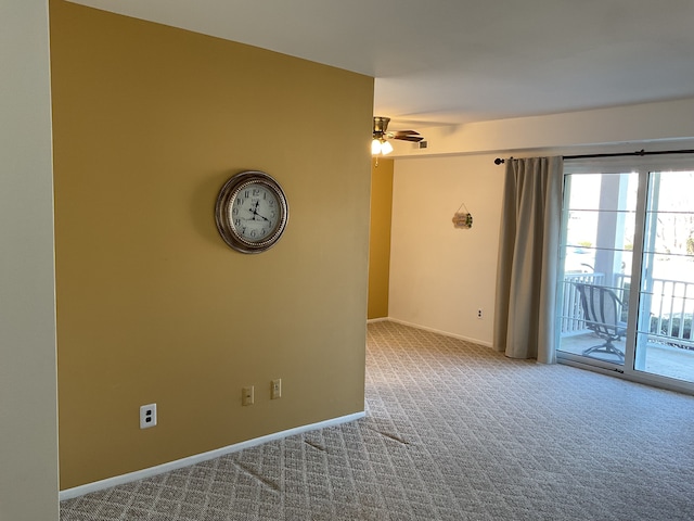 spare room with carpet floors, baseboards, and a ceiling fan