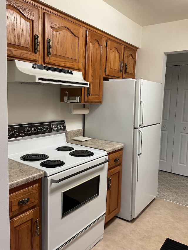 kitchen with light countertops, white appliances, brown cabinetry, and exhaust hood