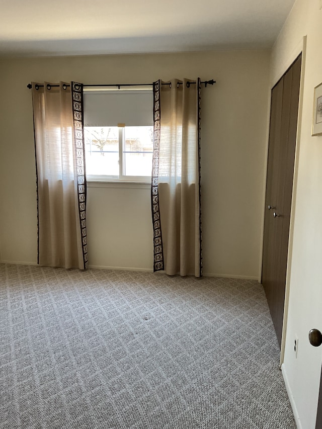 unfurnished room featuring carpet flooring