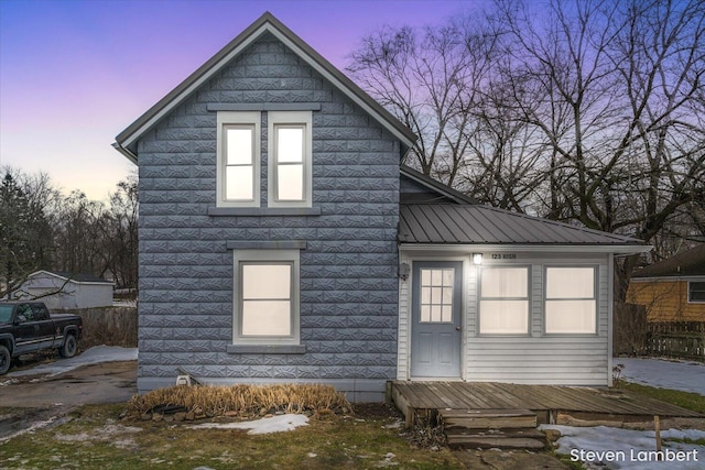 view of home's exterior featuring fence and metal roof