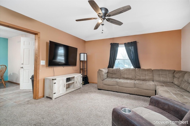 living room with baseboards, a ceiling fan, and light colored carpet