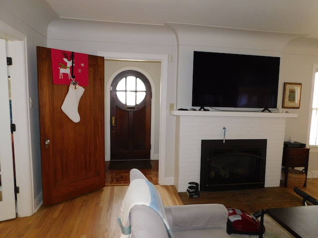 living area with a fireplace and wood finished floors