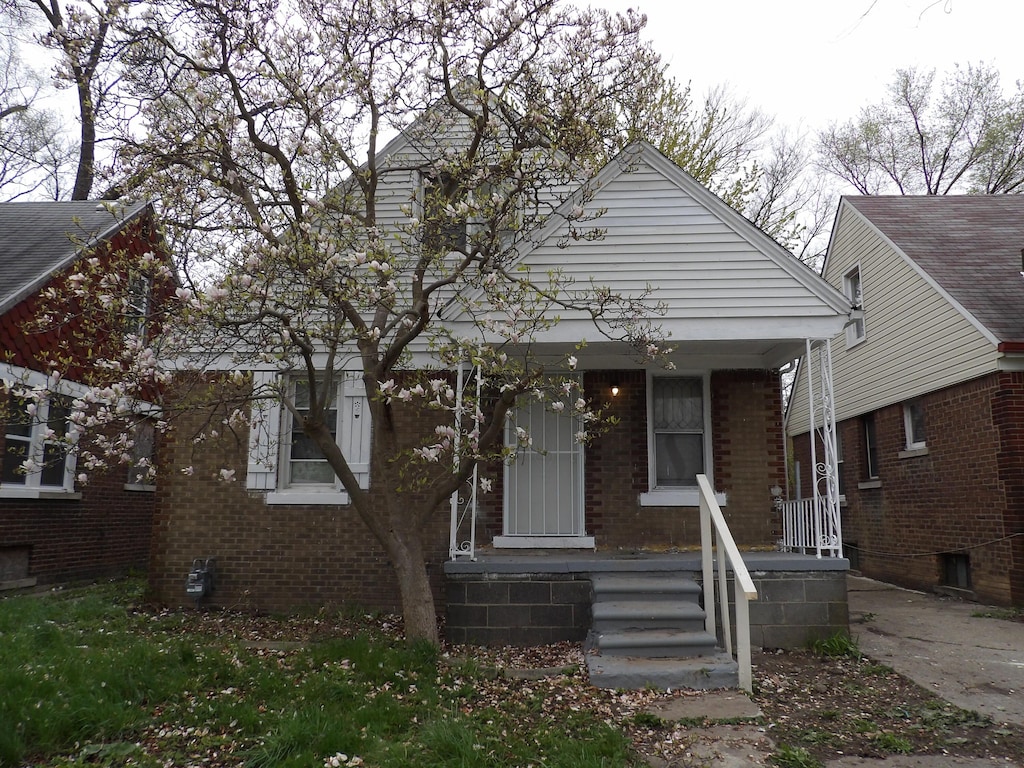 view of front of house featuring covered porch and brick siding