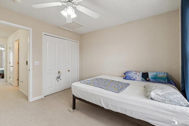 bedroom featuring carpet floors, a closet, attic access, a ceiling fan, and baseboards