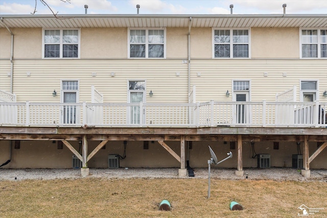 rear view of house with a deck and cooling unit