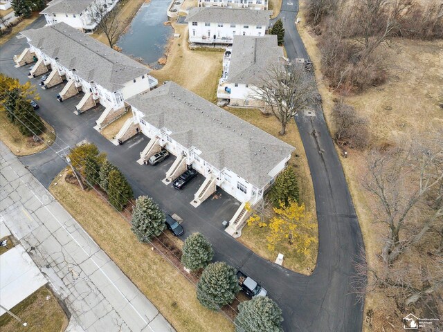 birds eye view of property with a water view