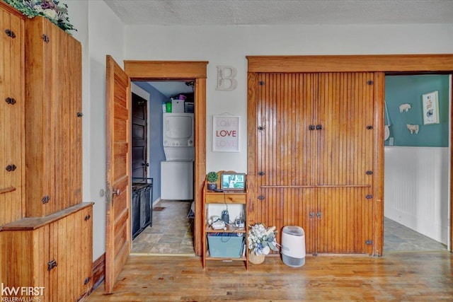 interior space featuring a textured ceiling and wood finished floors