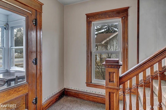 interior space featuring carpet floors, stairs, and baseboards