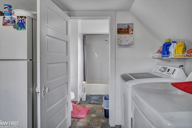 washroom with laundry area, stone finish floor, and independent washer and dryer