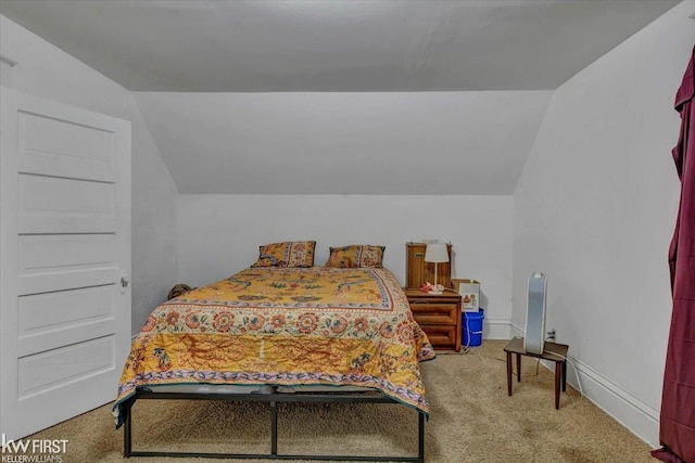 bedroom featuring lofted ceiling, carpet floors, and baseboards