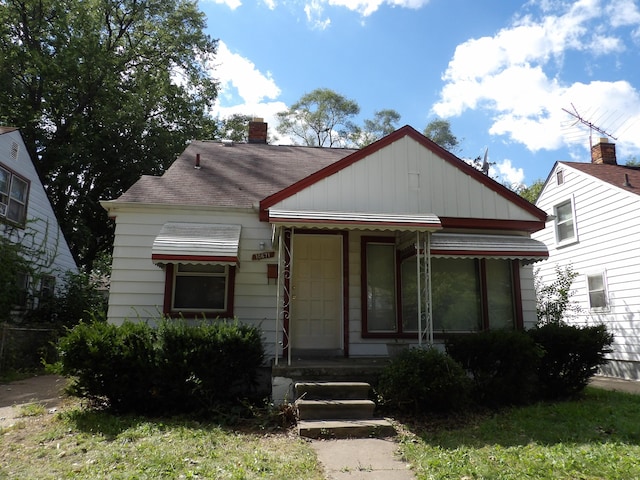 bungalow-style house featuring a chimney