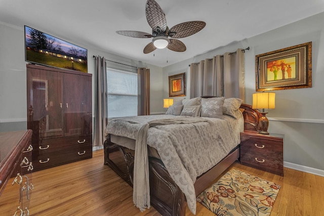 bedroom featuring baseboards, ceiling fan, and light wood finished floors