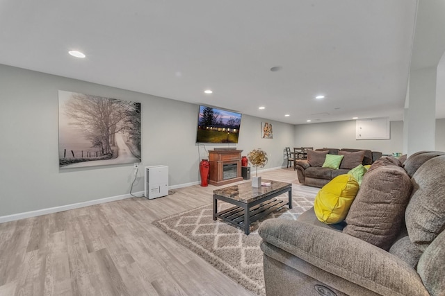 living room featuring recessed lighting, baseboards, and wood finished floors