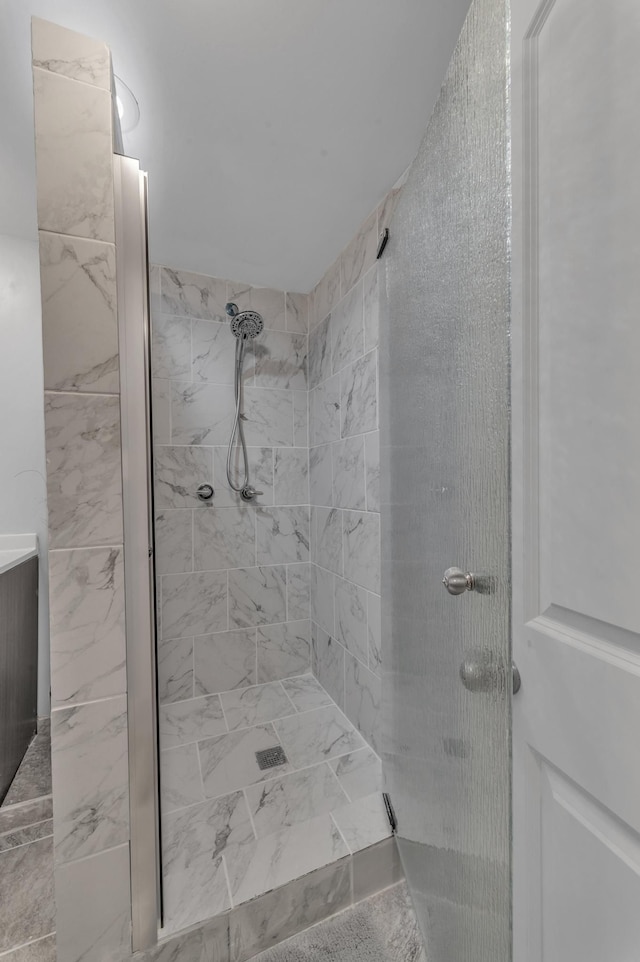 full bathroom with a tile shower