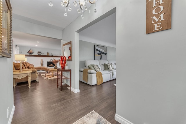 living area featuring baseboards and dark wood-style flooring