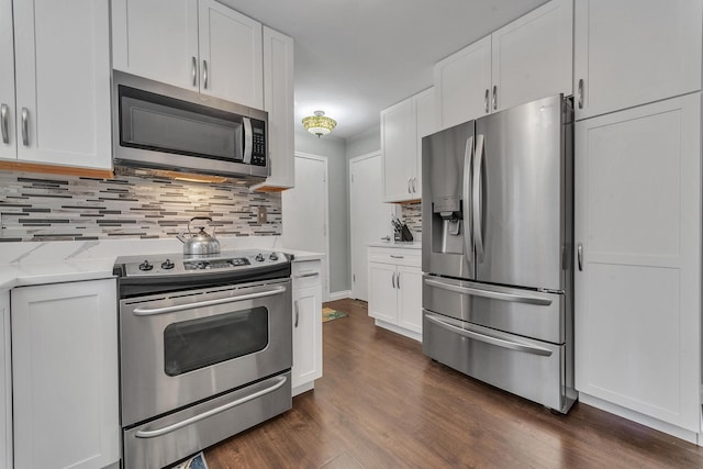 kitchen with white cabinetry, tasteful backsplash, and stainless steel appliances