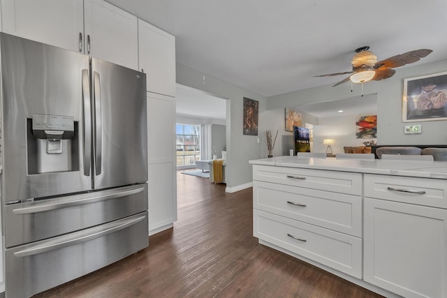 kitchen with dark wood-style floors, open floor plan, stainless steel fridge with ice dispenser, and white cabinets