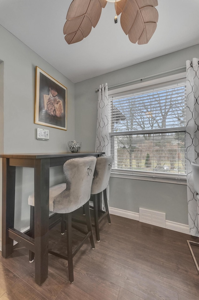 dining area with plenty of natural light, wood finished floors, and visible vents