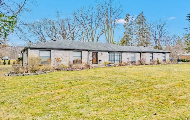 single story home featuring a front yard and brick siding