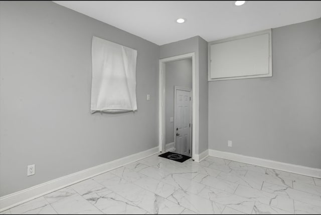 unfurnished bedroom with marble finish floor, recessed lighting, and baseboards