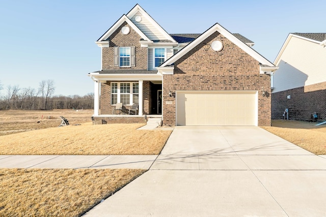 view of front of house with a garage, brick siding, a porch, and driveway