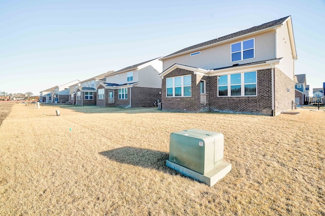 view of front of home with brick siding and a residential view