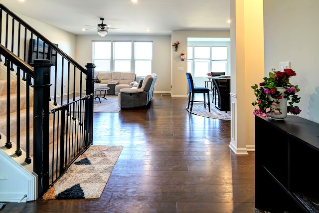 living room featuring stairway, a ceiling fan, baseboards, dark wood finished floors, and recessed lighting