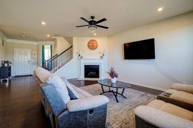 living area with baseboards, a fireplace with flush hearth, stairway, recessed lighting, and dark wood-style floors