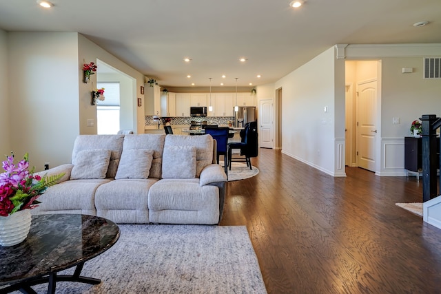 living area featuring recessed lighting, visible vents, and dark wood-style floors