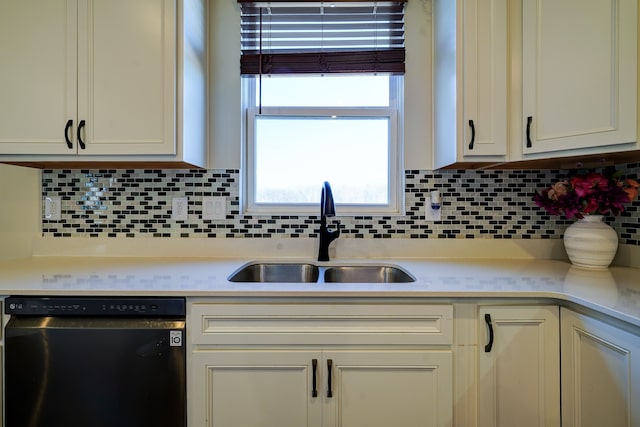 kitchen with tasteful backsplash, dishwasher, light countertops, and a sink