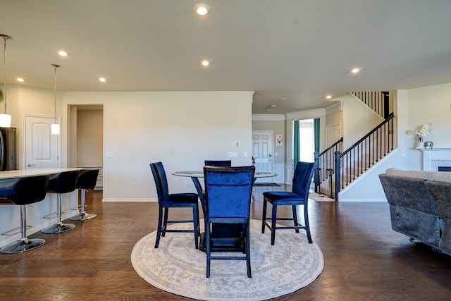 dining area with recessed lighting, crown molding, stairs, and dark wood-type flooring