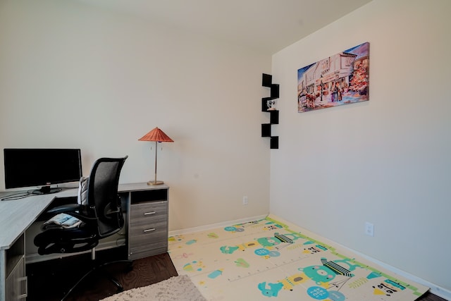 office area with baseboards and wood finished floors