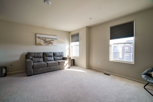 carpeted living room featuring baseboards and visible vents