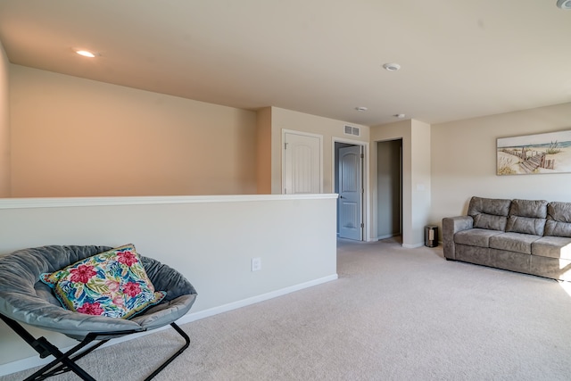 sitting room featuring recessed lighting, visible vents, baseboards, and light colored carpet