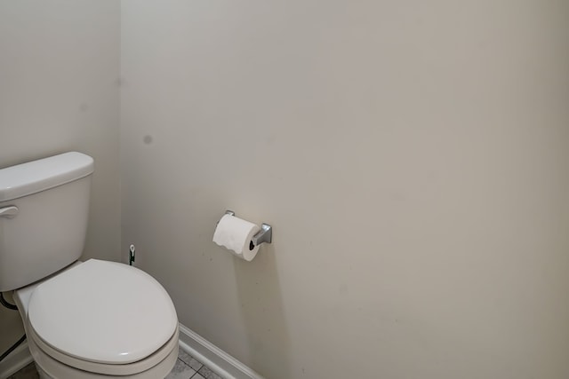 bathroom with baseboards and toilet