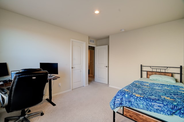 bedroom with visible vents, baseboards, and light carpet