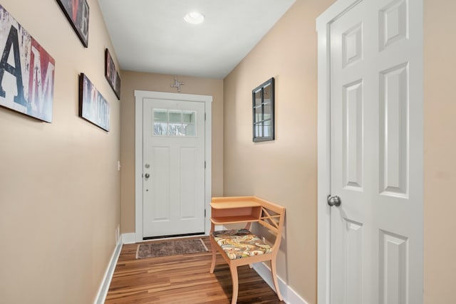 entryway with baseboards and wood finished floors