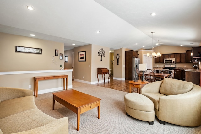 living room featuring a chandelier, recessed lighting, vaulted ceiling, and baseboards