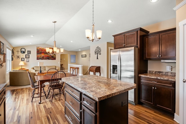 kitchen featuring light wood-style flooring, lofted ceiling, a center island, and stainless steel refrigerator with ice dispenser