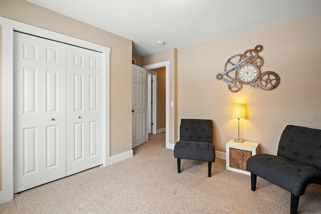 sitting room featuring light carpet and baseboards