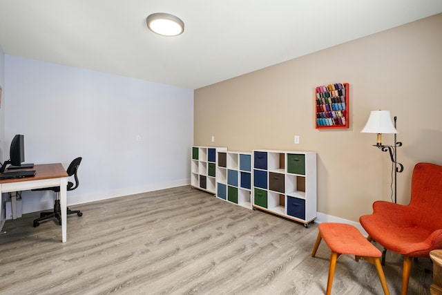 office featuring light wood-type flooring and baseboards