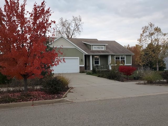 view of front of home featuring concrete driveway, stone siding, roof with shingles, and an attached garage