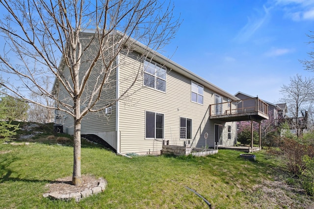 back of property with a lawn and a deck